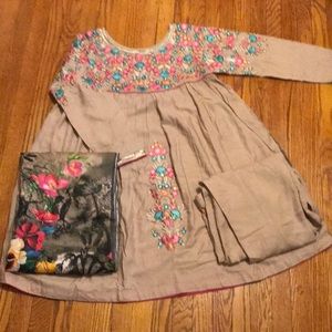 It’s a tan dress with colorful flowers on it